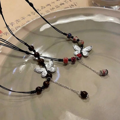 Aurora Papillon et Perle Collier - Une Élégance Envoûtante