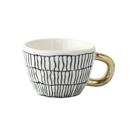 Tasse avec motif géométrique abstrait et anse dorée