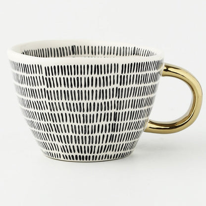 Tasse avec motif géométrique abstrait et anse dorée