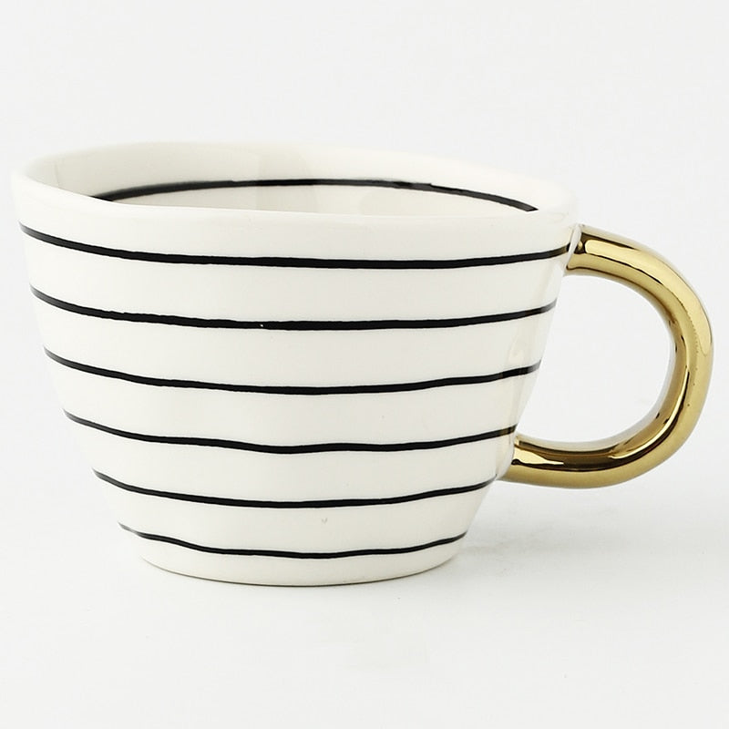 Tasse avec motif géométrique abstrait et anse dorée