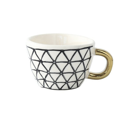 Tasse avec motif géométrique abstrait et anse dorée