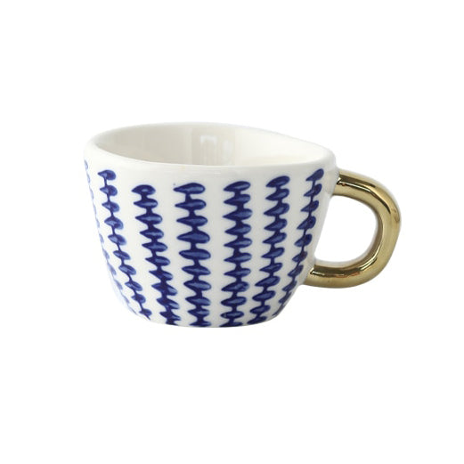 Tasse avec motif géométrique abstrait et anse dorée