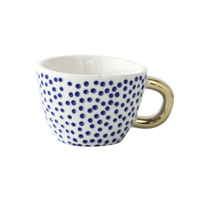Tasse avec motif géométrique abstrait et anse dorée